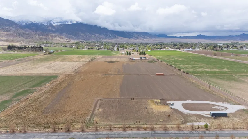 View of rural area featuring a mountainous background and large plots for crops