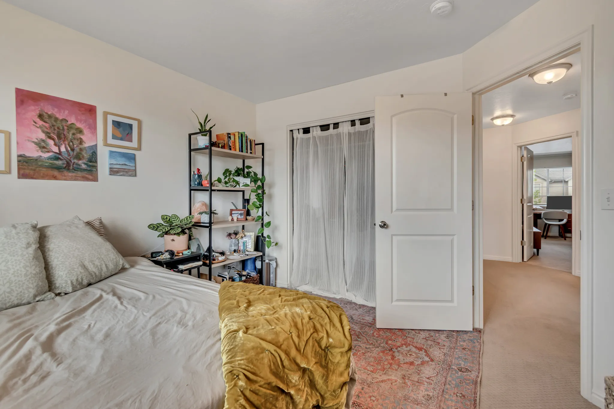 Bedroom featuring light colored carpet and a closet