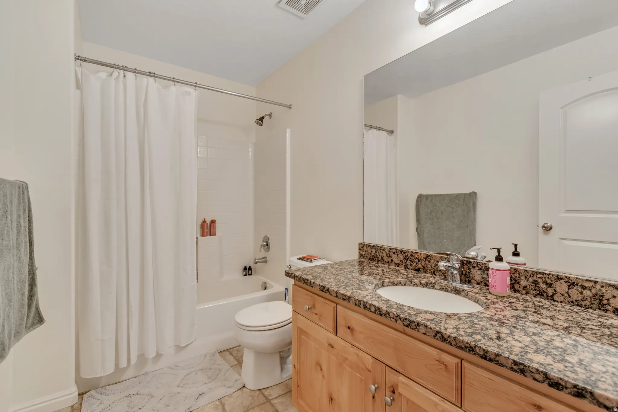Bathroom with vanity and shower / bath combo