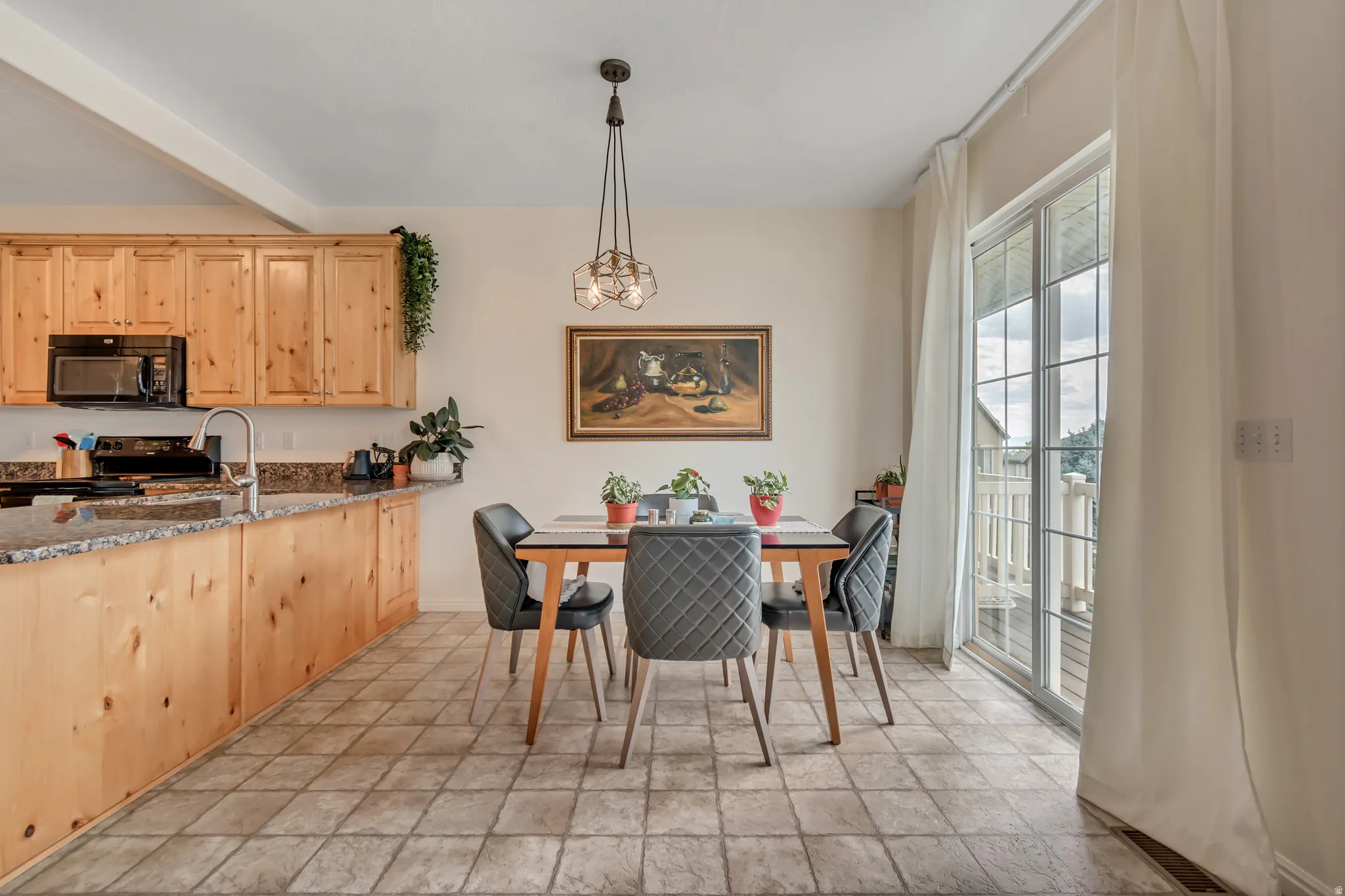 Dining space with light tile finish floors
