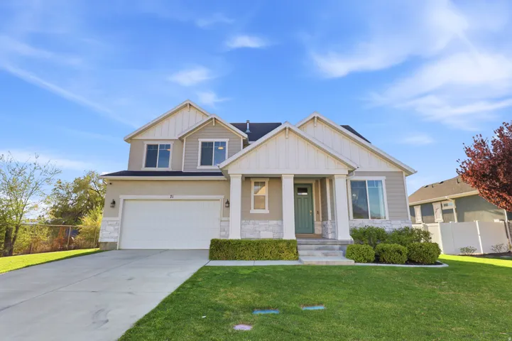 Craftsman-style house with stone siding, board and batten siding, concrete driveway, and an attached garage
