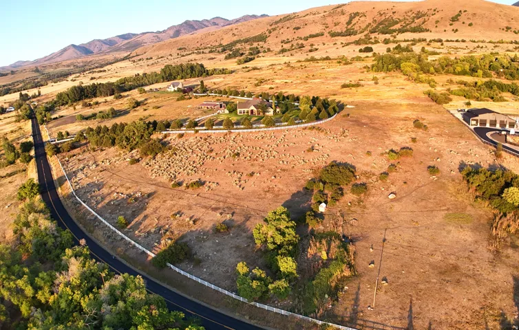 View of rural area with a mountain backdrop and a desert landscape