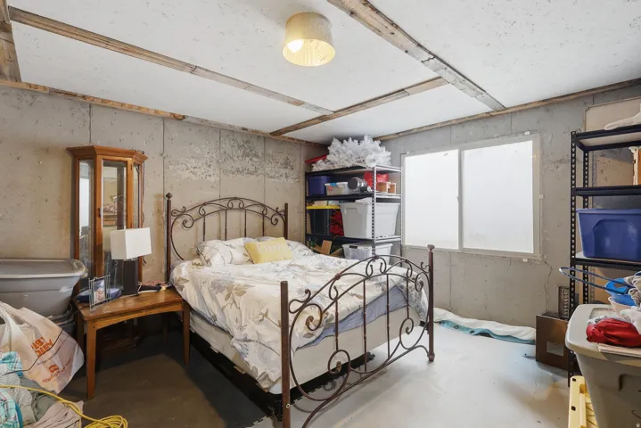 Bedroom with concrete flooring