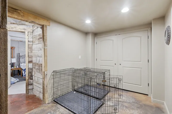 Hall with unfinished concrete floors and recessed lighting