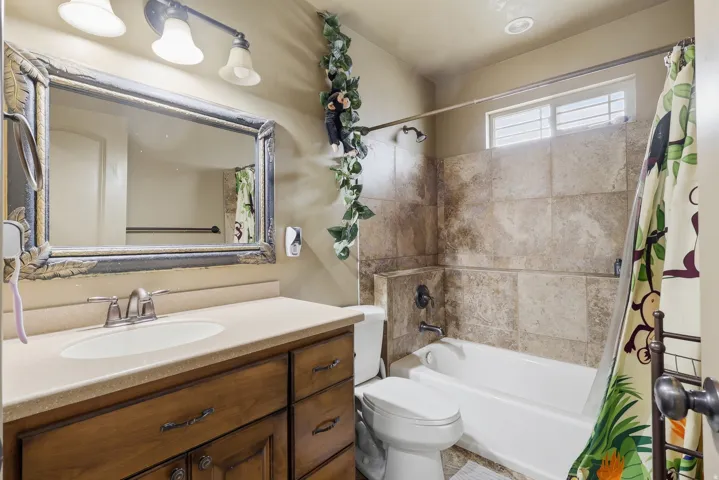 Full bath featuring vanity and shower / bath combination with curtain