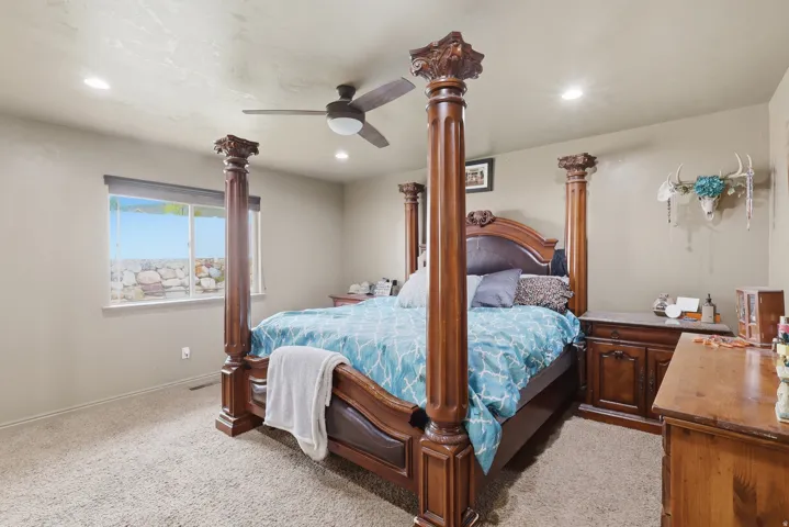 Bedroom featuring ceiling fan, light colored carpet, and recessed lighting