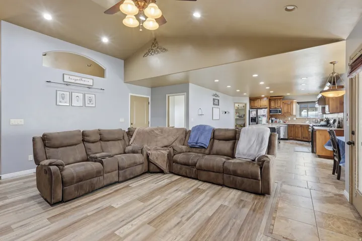 Living area featuring recessed lighting, vaulted ceiling, ceiling fan, and light wood-type flooring