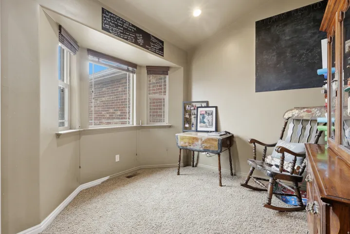 Office space with light carpet and lofted ceiling