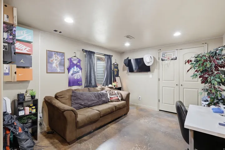 Room with finished floors and recessed lighting