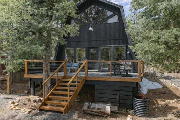 Rear view of house featuring a deck and a sunroom