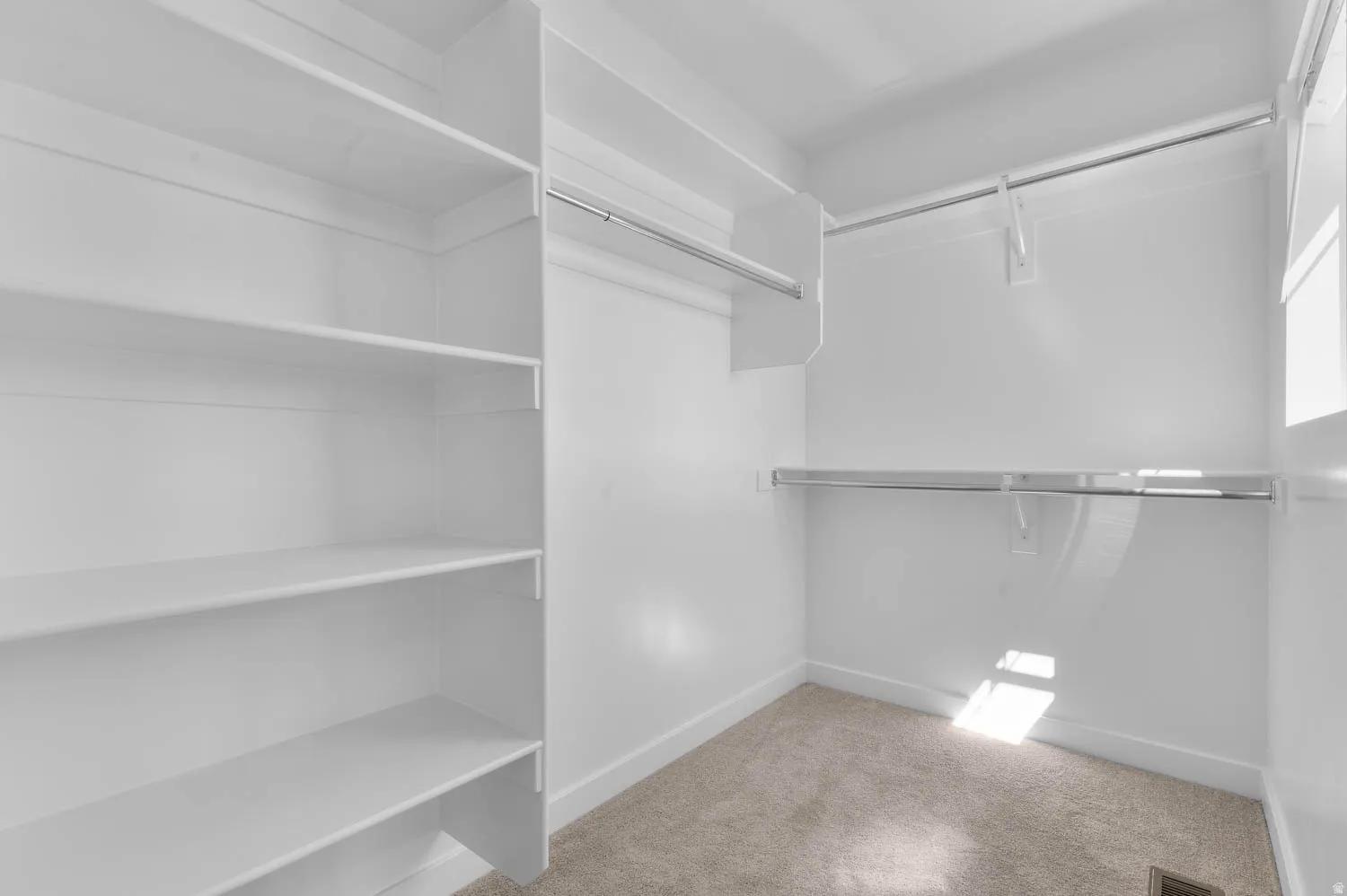 Walk in closet featuring light carpet