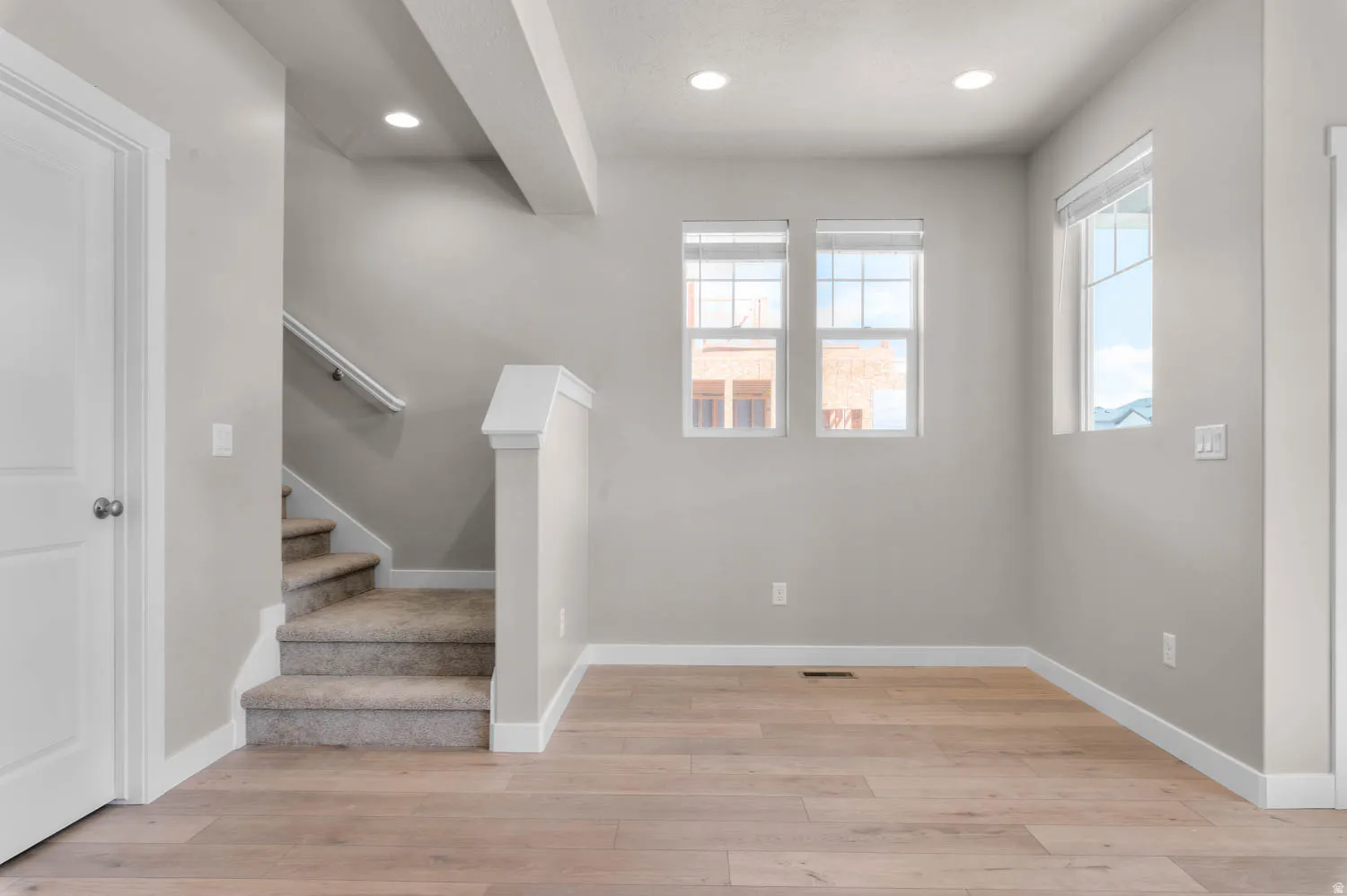 Stairs featuring recessed lighting and wood finished floors