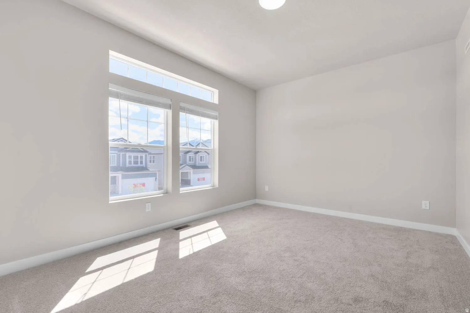 Unfurnished room with light carpet and baseboards