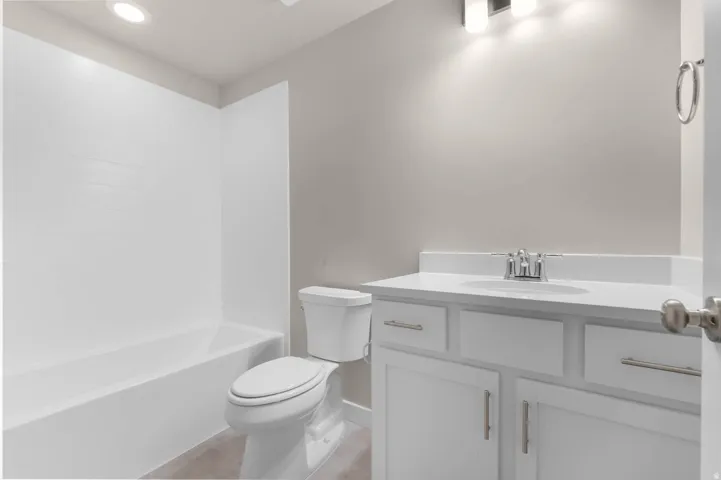 Bathroom featuring vanity, recessed lighting, and tub / shower combination