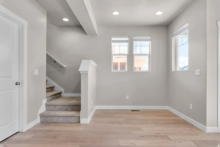 Stairs featuring recessed lighting and wood finished floors