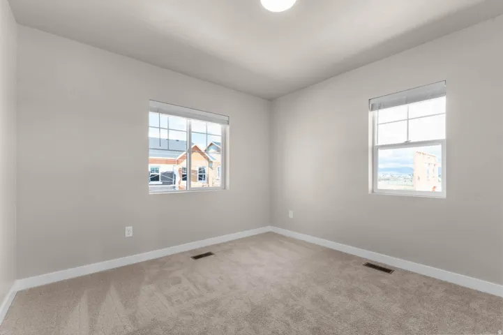 Empty room with baseboards and light carpet