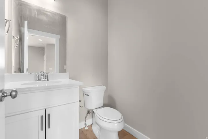 Half bath featuring vanity and toilet