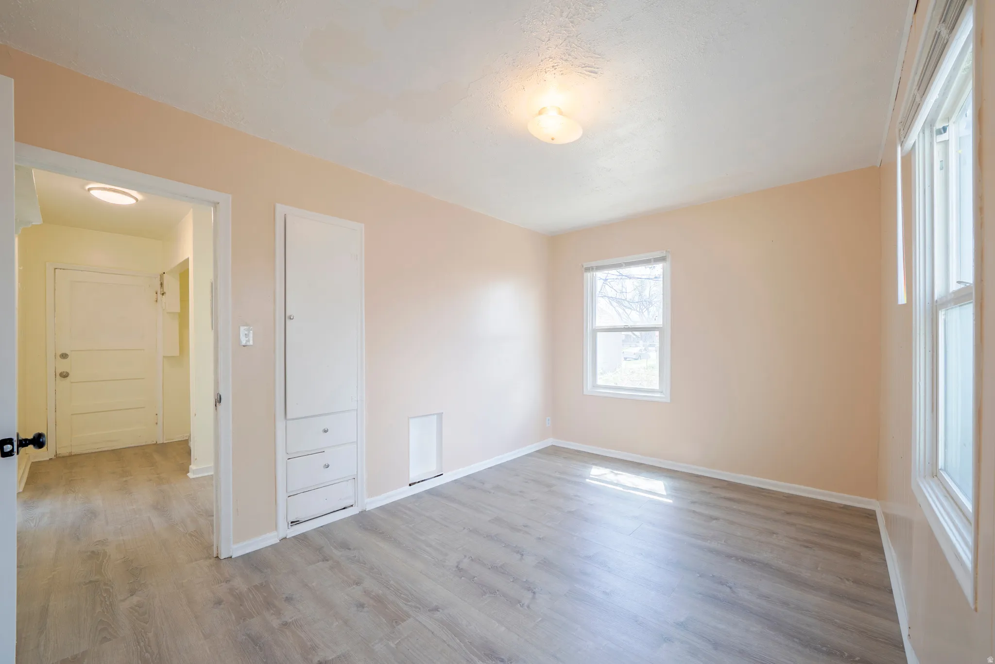 Unfurnished bedroom featuring light wood-style flooring