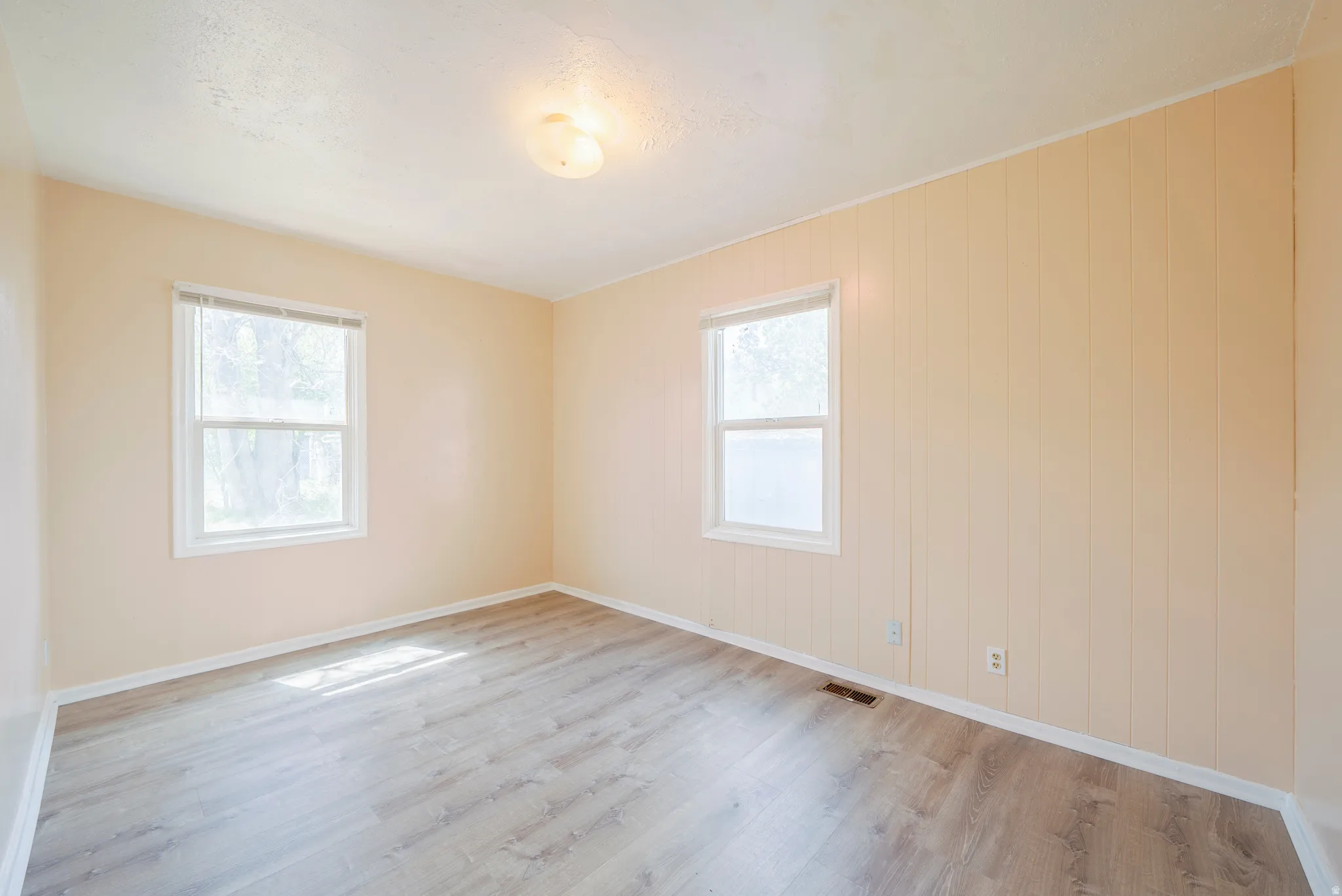 Unfurnished room featuring light wood-style flooring and baseboards