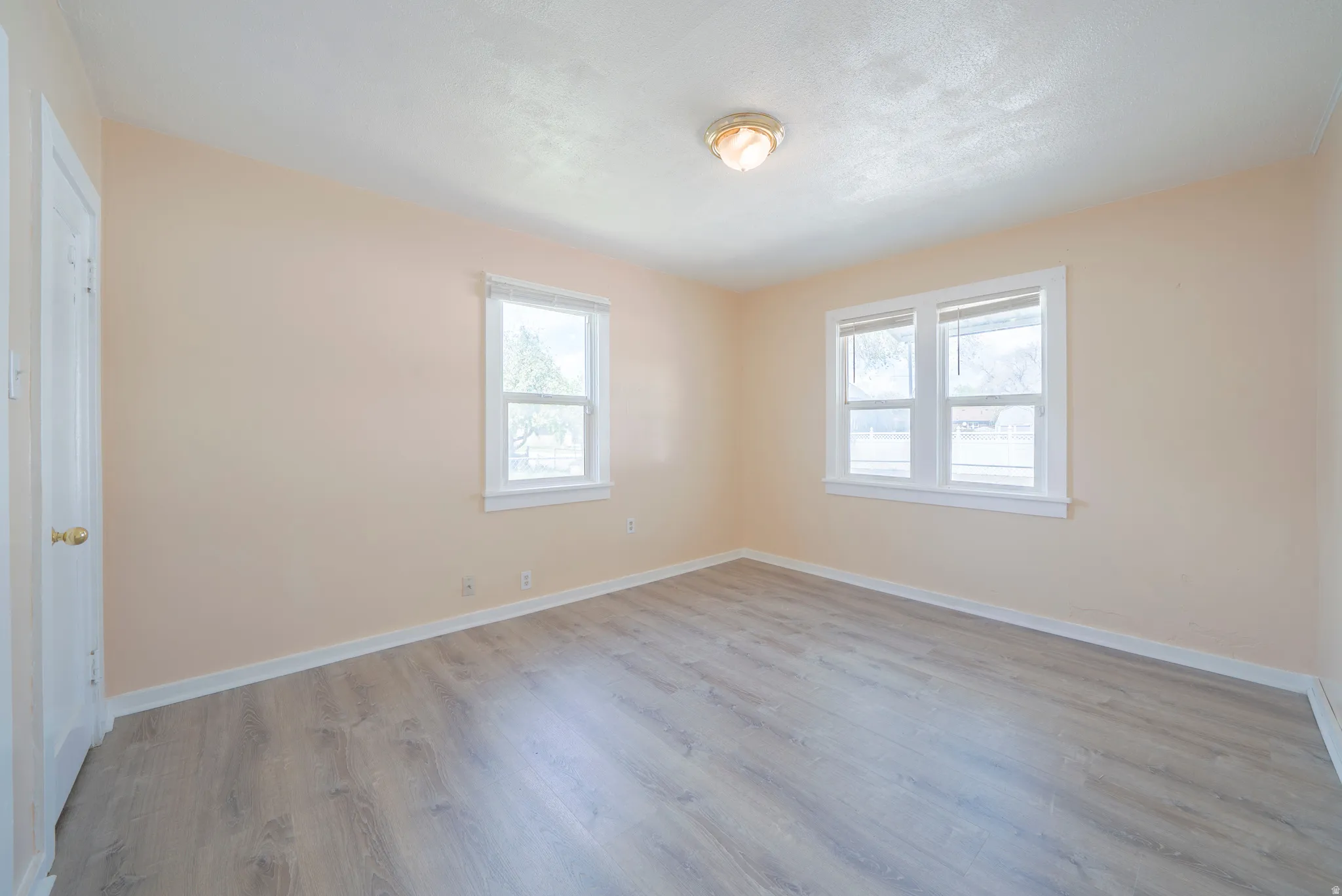 Unfurnished bedroom featuring baseboards and light wood-style floors