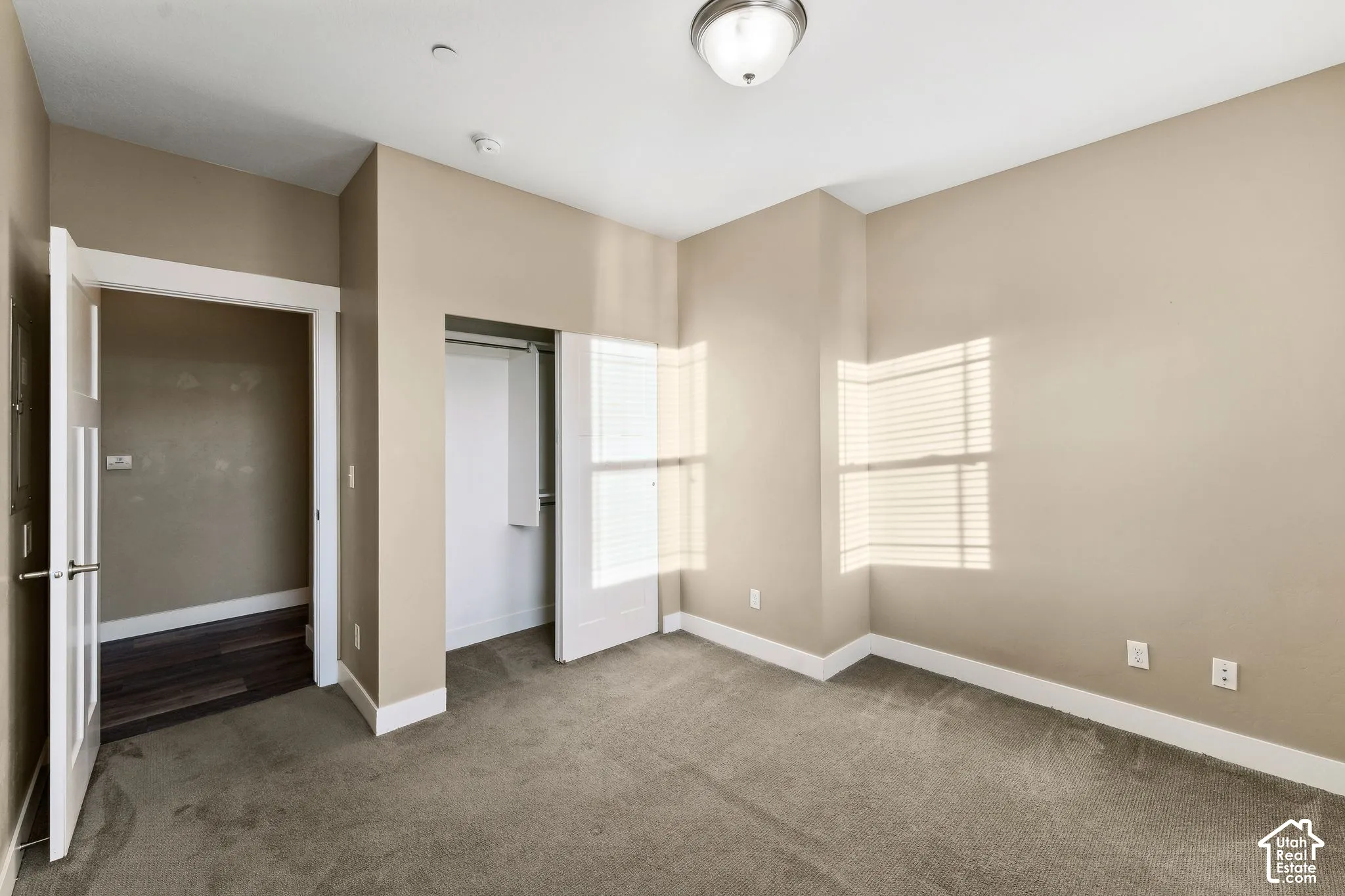 Unfurnished bedroom with a closet and carpet floors