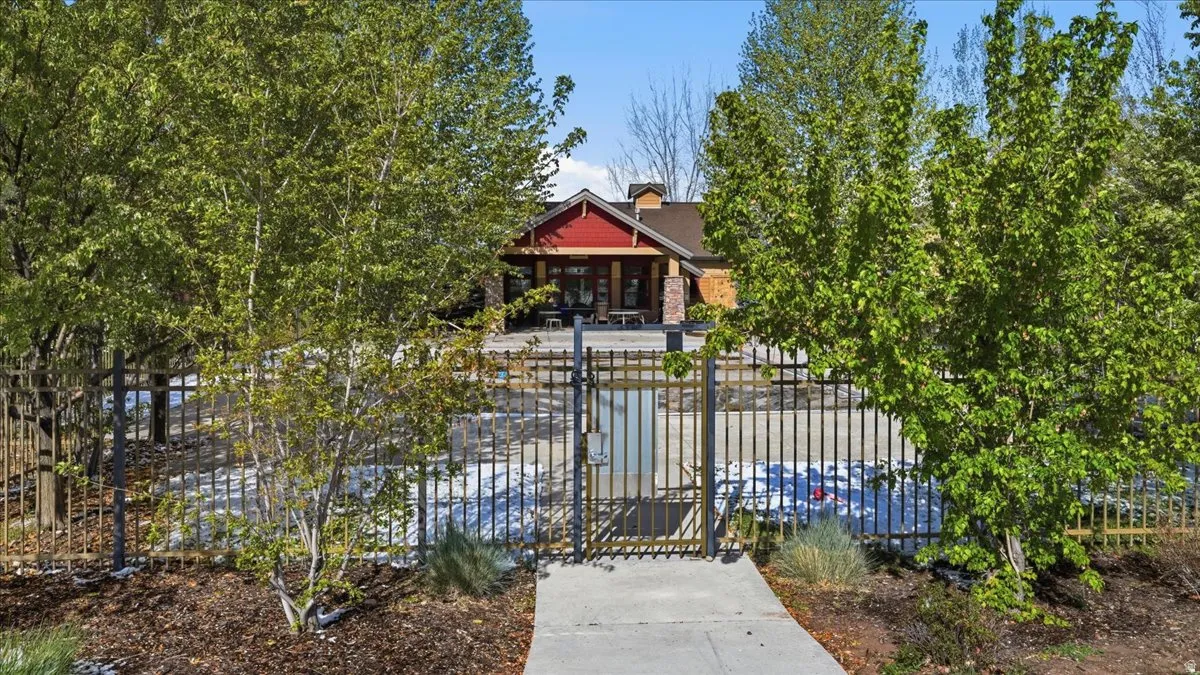 View of front of property with a fenced front yard, a gate, covered porch, and a chimney
