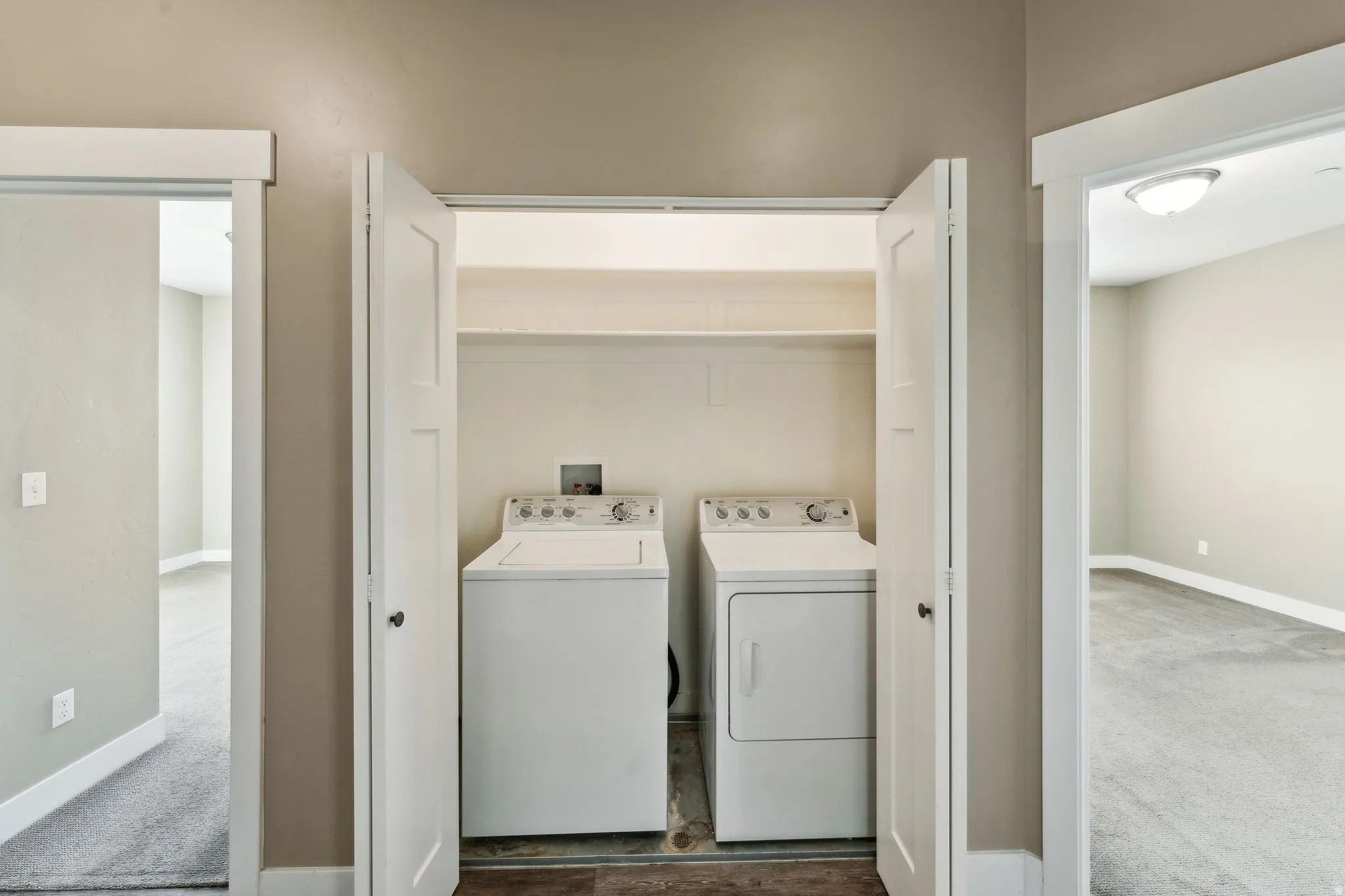 Laundry area featuring washer and clothes dryer and carpet floors