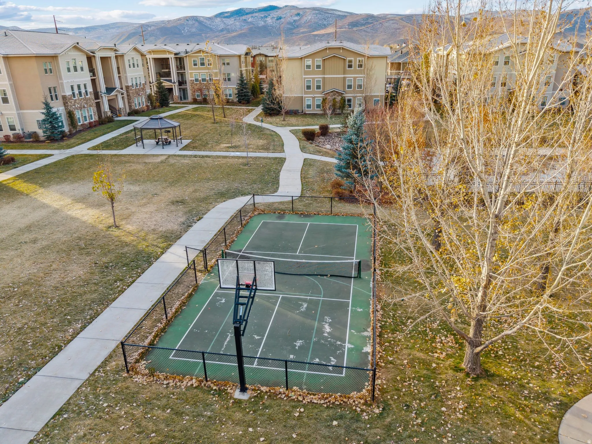 View of home's community with a mountain view, community basketball court, and a residential view