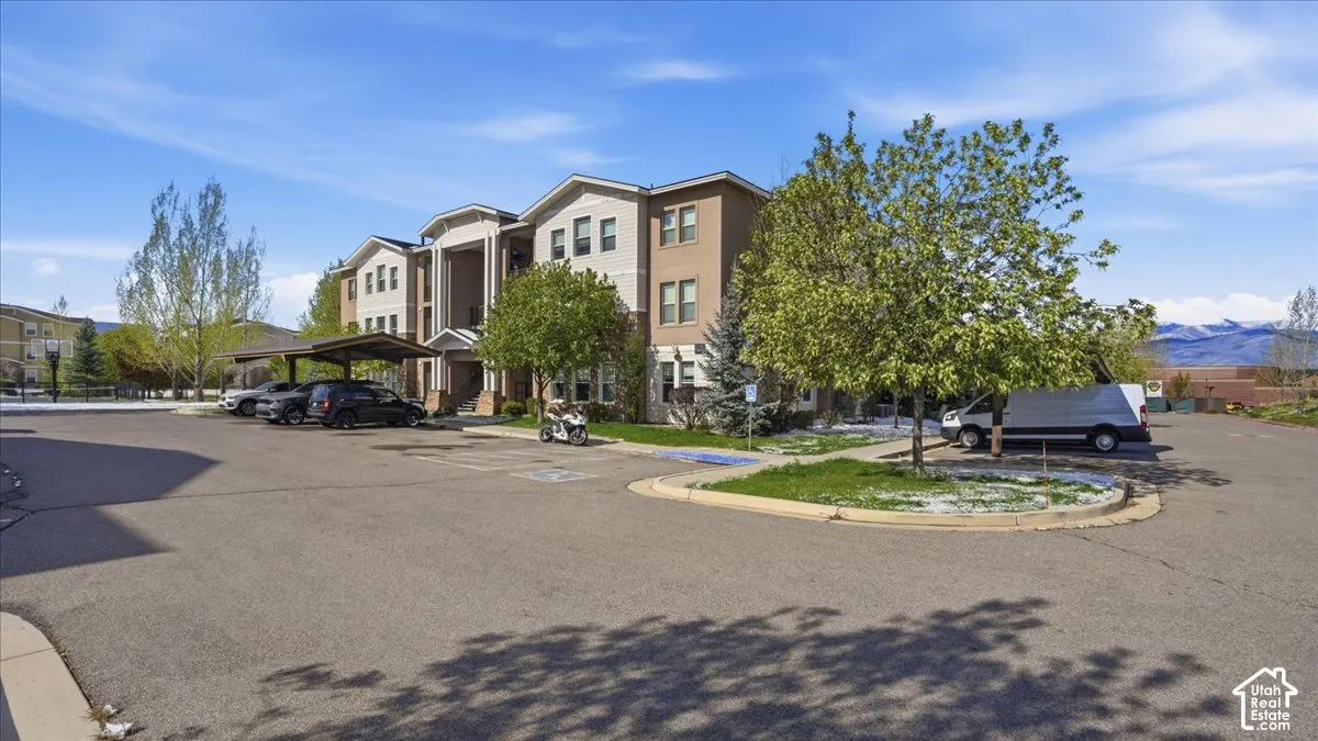 View of property featuring a mountain view and covered parking