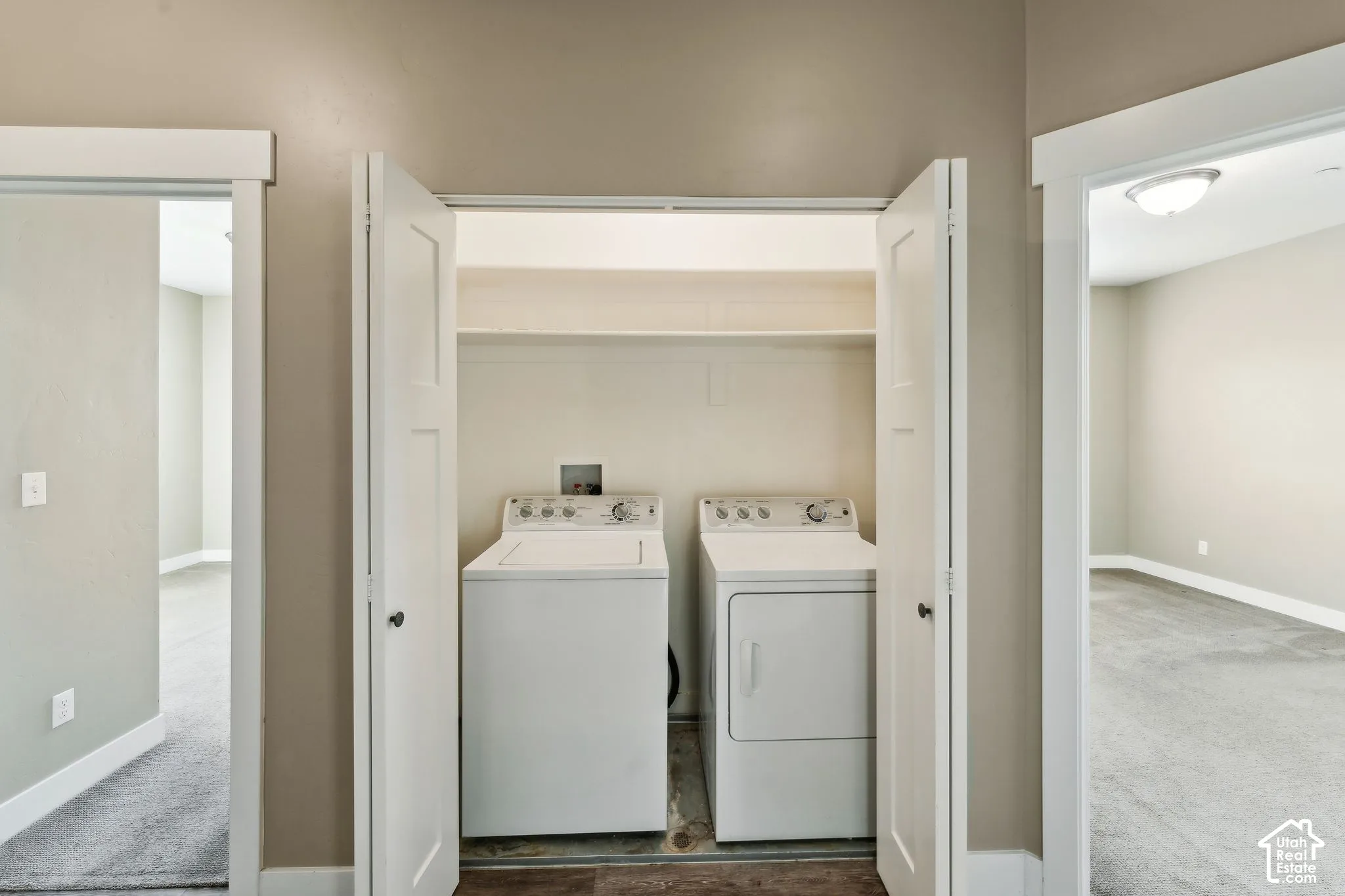 Laundry area featuring washer and clothes dryer and carpet floors