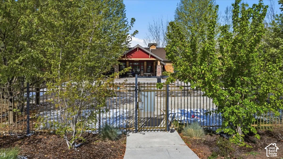 View of front of property with a fenced front yard, a gate, covered porch, and a chimney