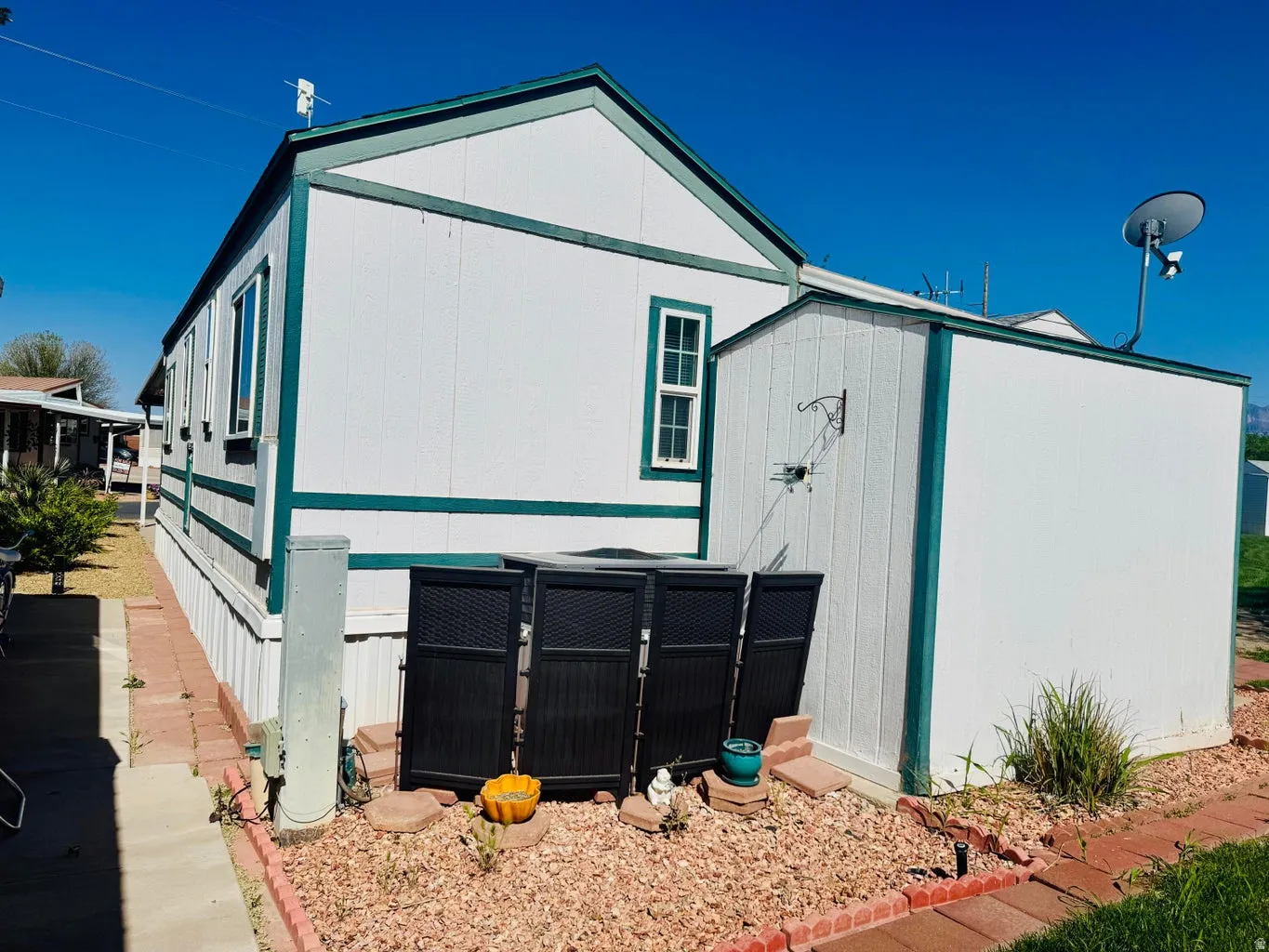 View of side of property featuring a storage shed