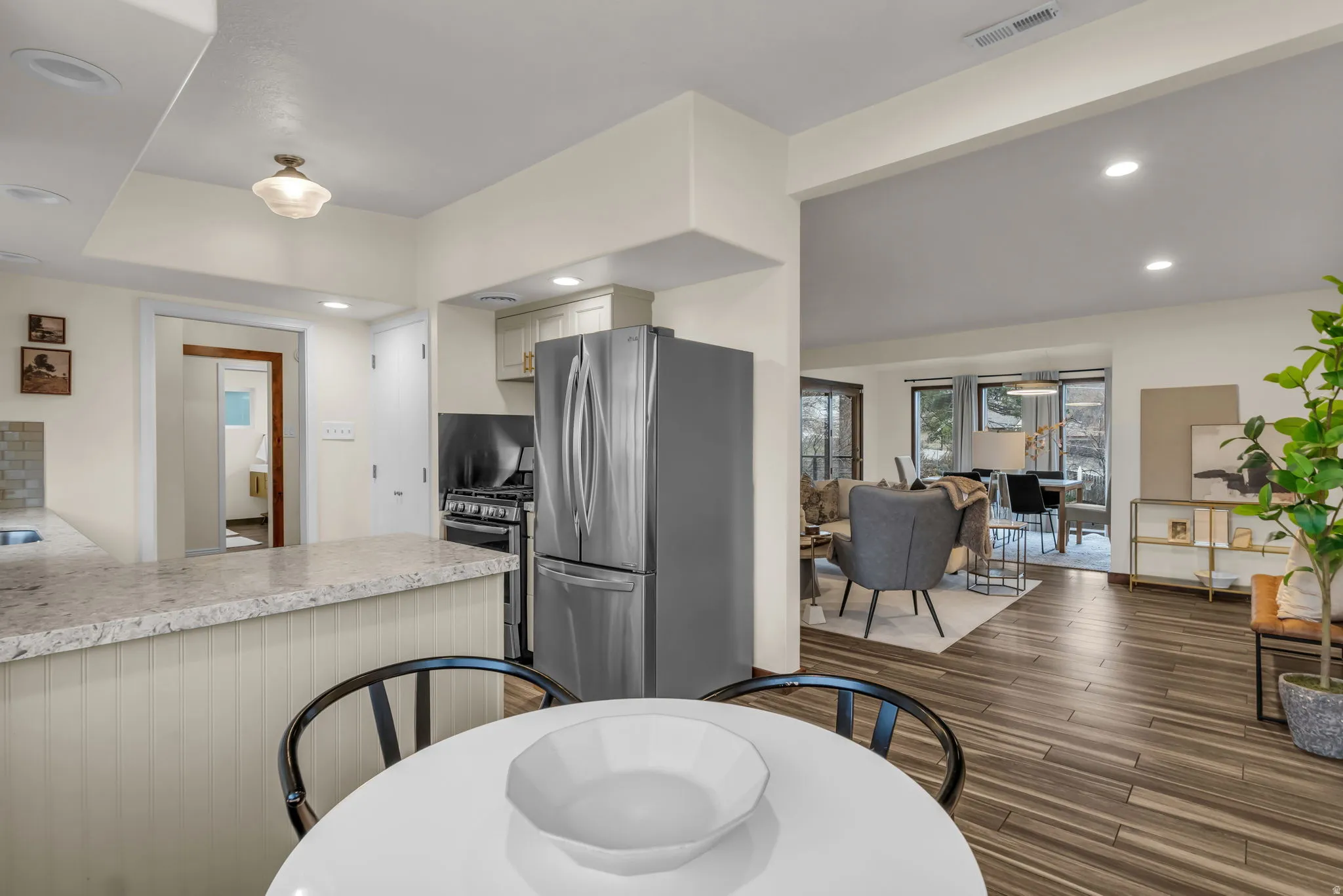 Dining space with recessed lighting and dark wood-style flooring