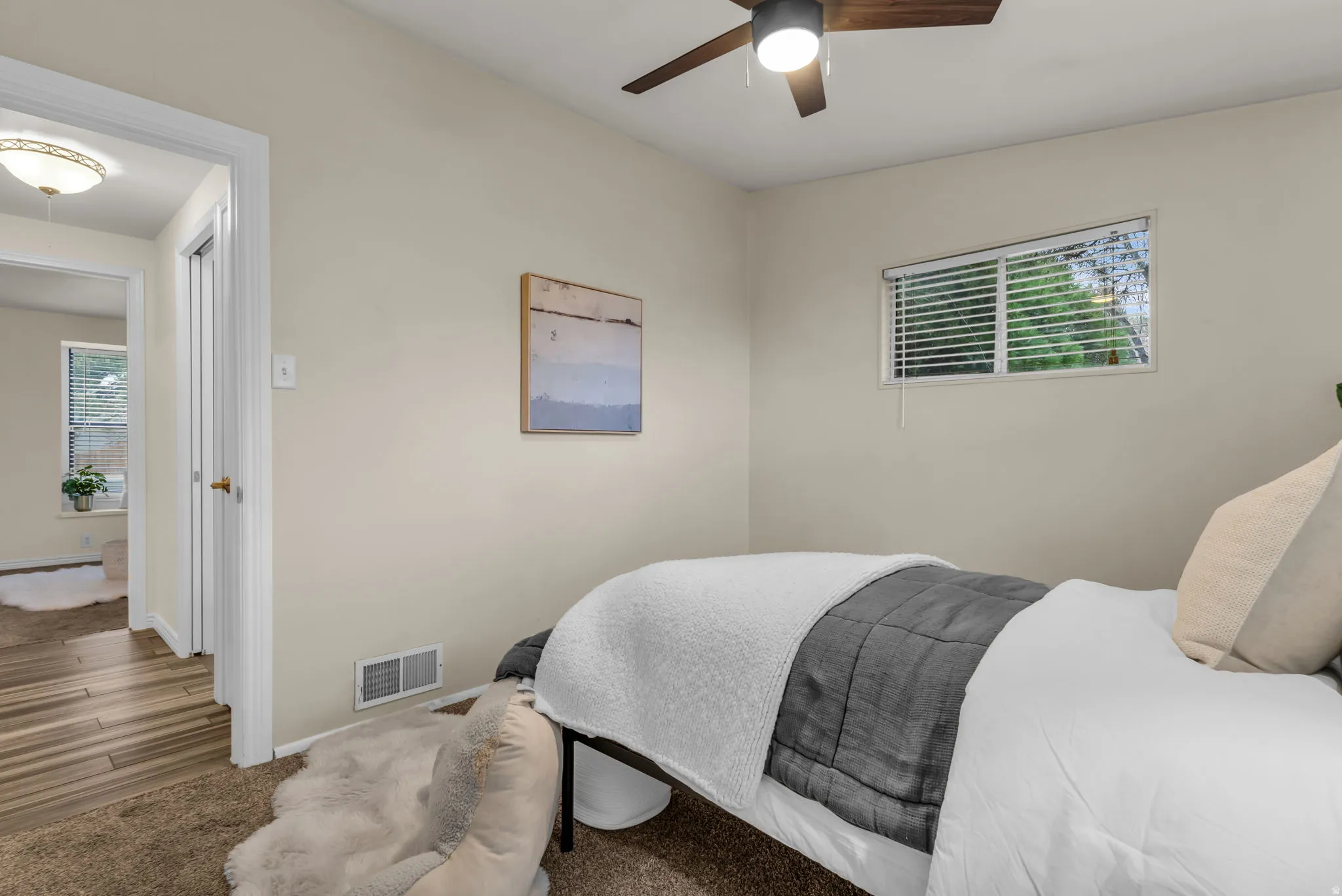 Bedroom with carpet flooring and a ceiling fan