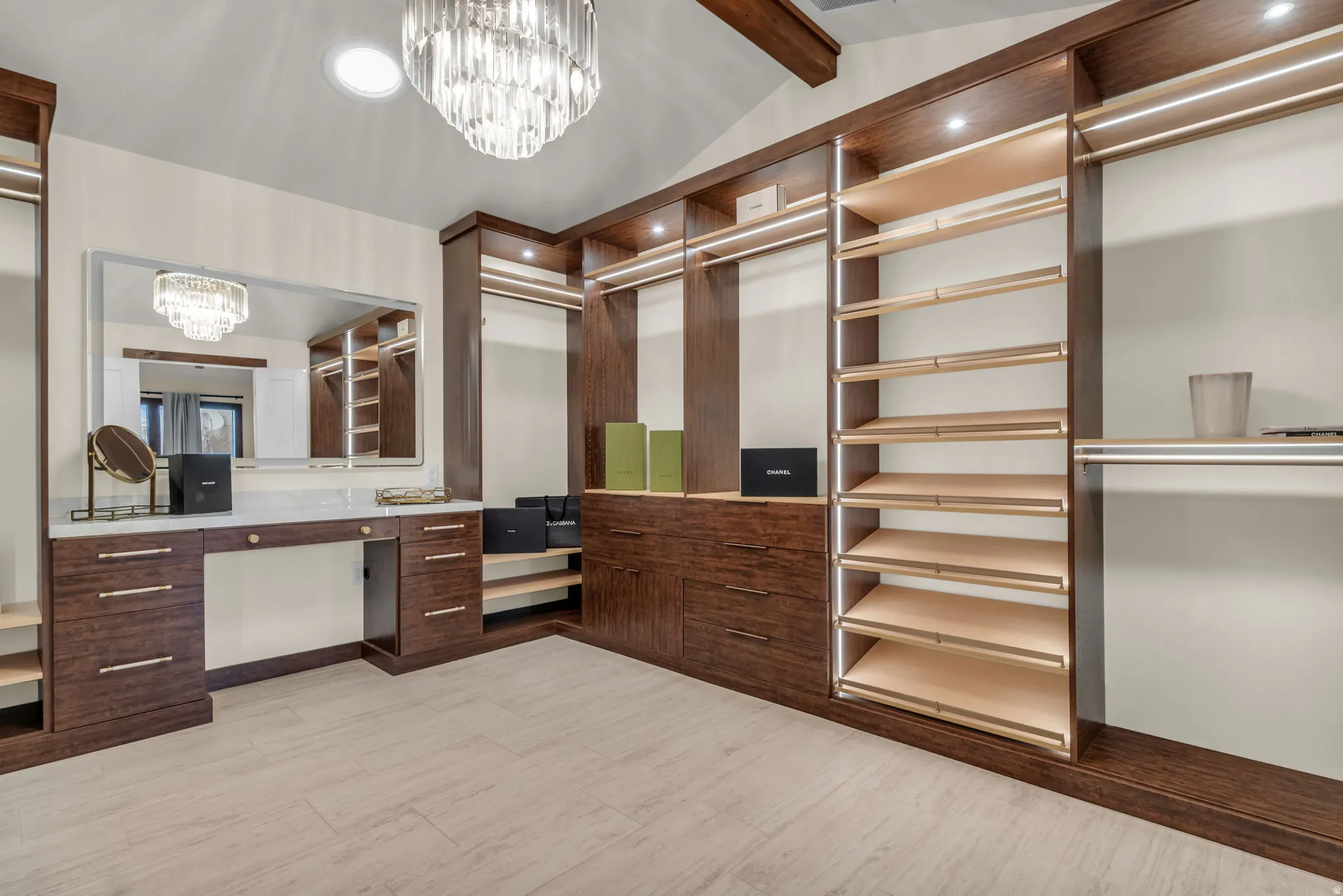 Walk in closet featuring hanging lights and beamed ceiling