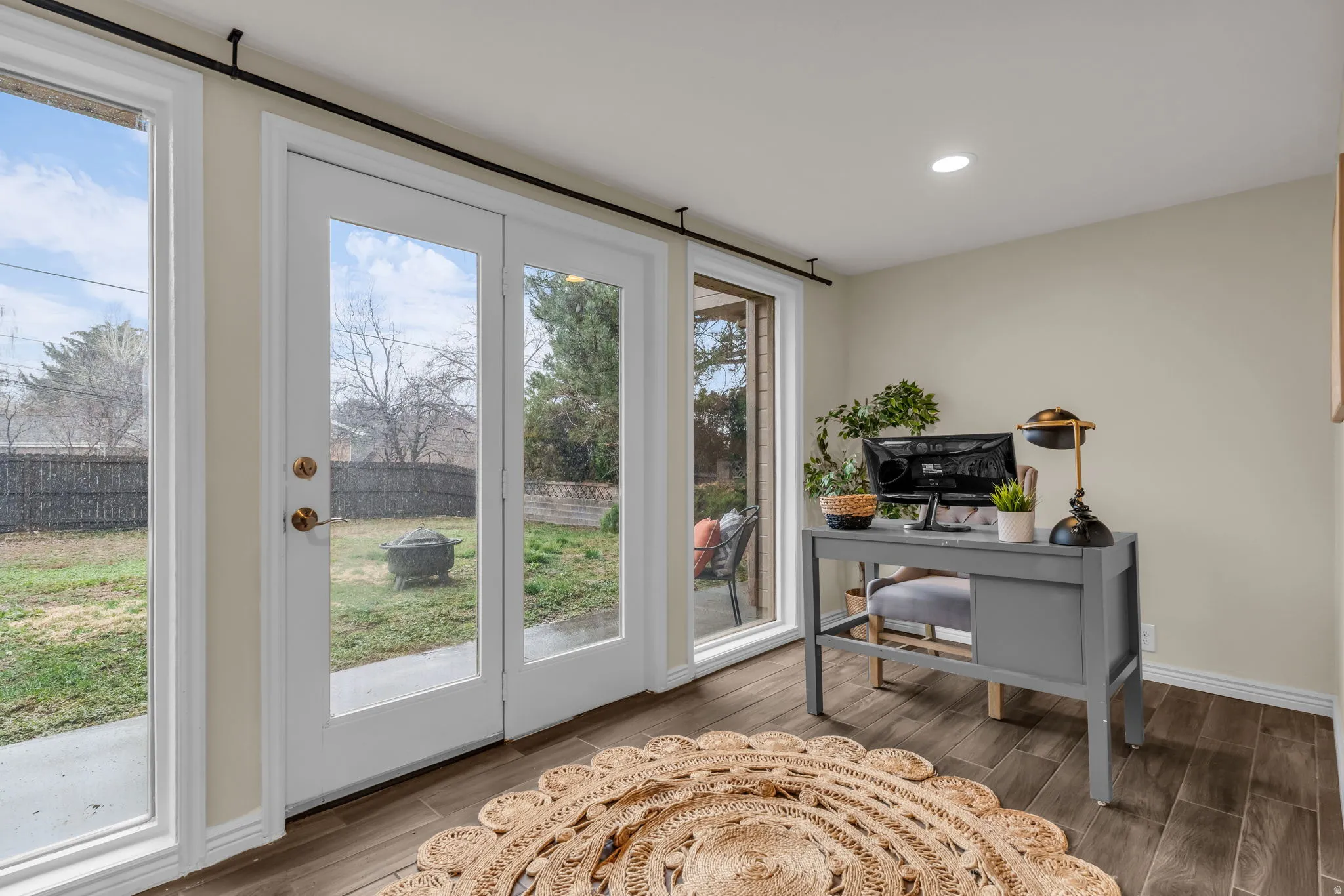 Office space with light wood-style floors and recessed lighting