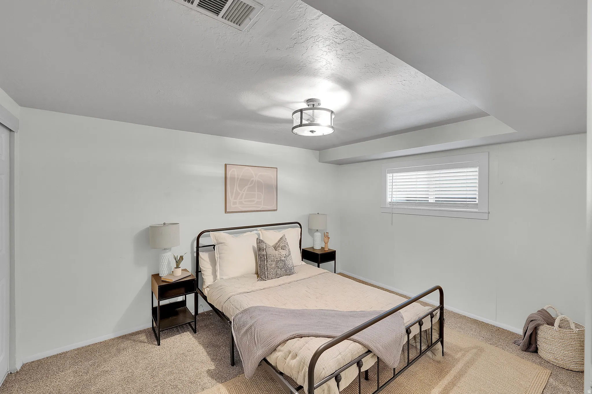 Bedroom featuring light carpet and baseboards