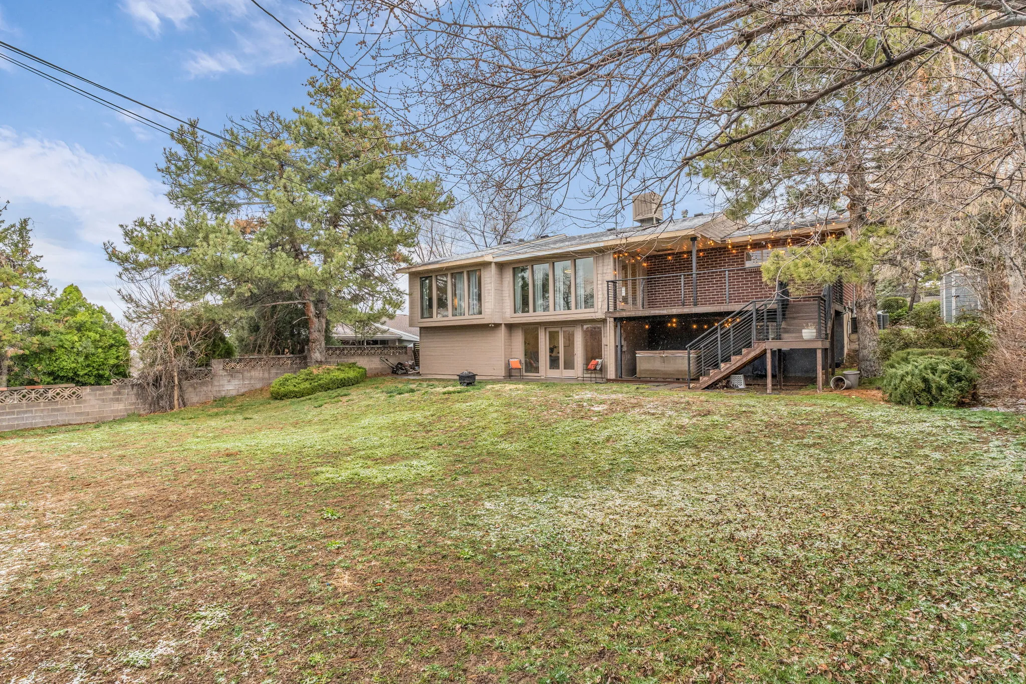 Back of house featuring a chimney, a patio, and a wooden deck