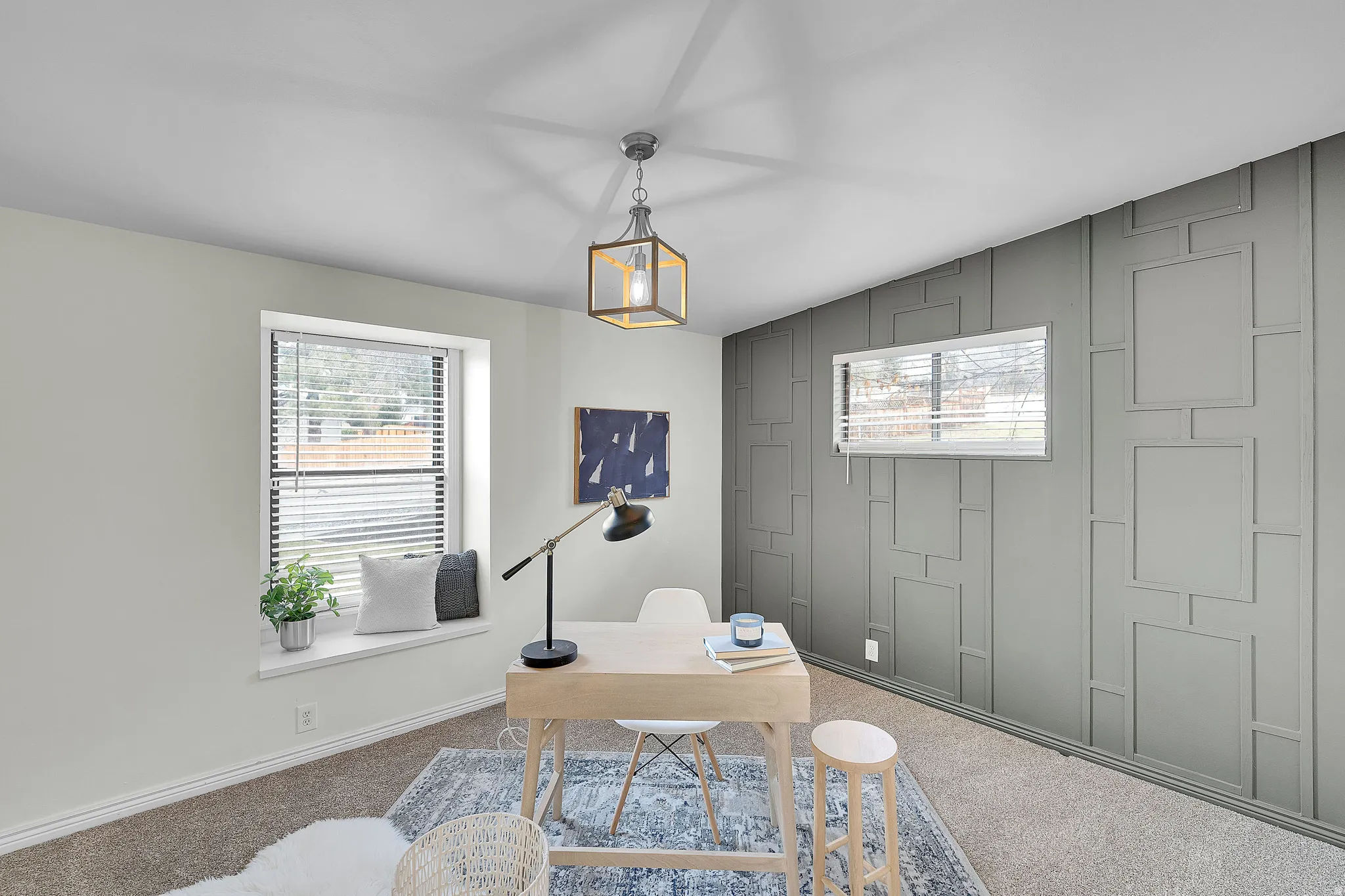 Carpeted office with baseboards and an accent wall