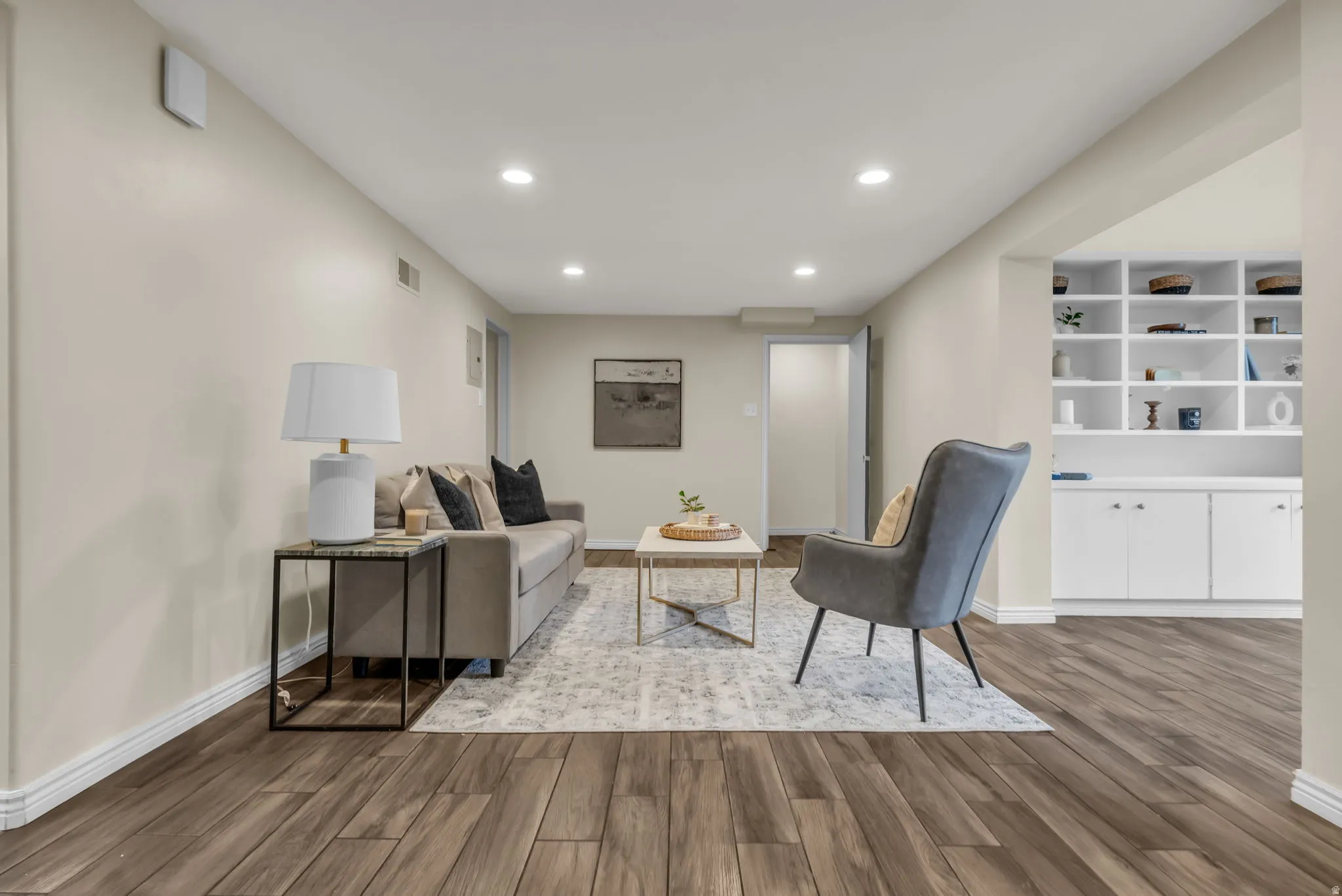 Living area with dark wood-style flooring and recessed lighting