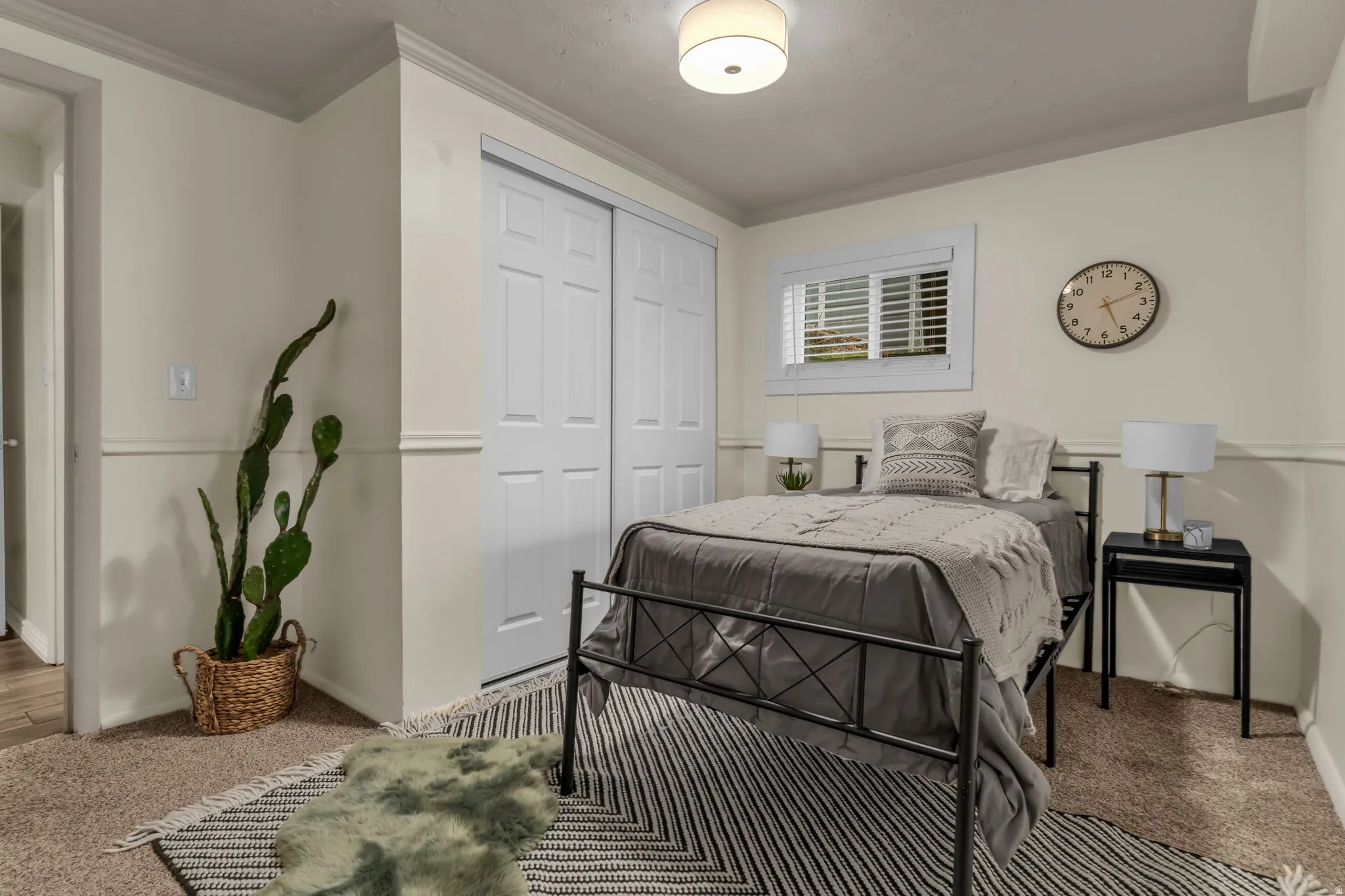 Bedroom featuring carpet flooring, a closet, and ornamental molding