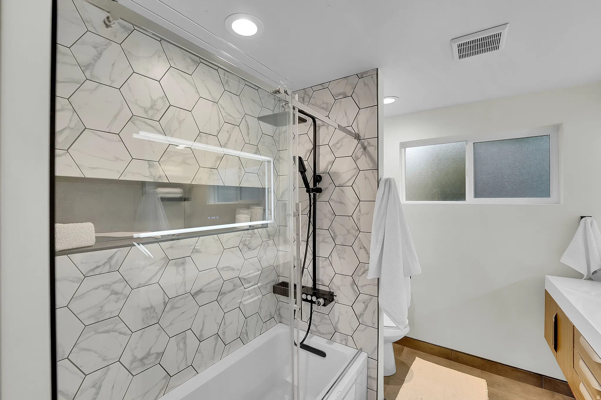 Full bathroom with vanity, shower / bath combination with glass door, and recessed lighting