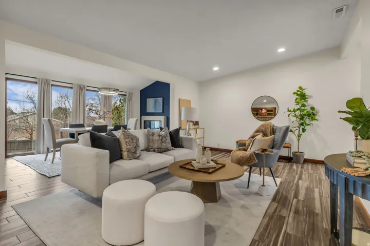 Living area with wood finished floors and recessed lighting