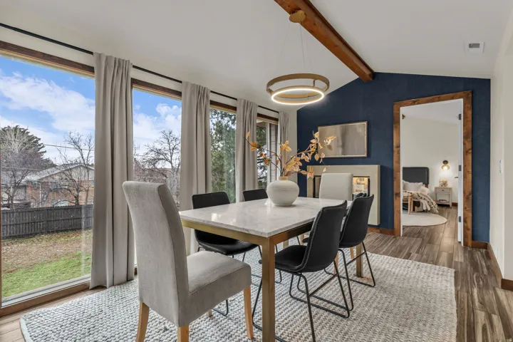 Dining area with dark wood-type flooring and beam ceiling