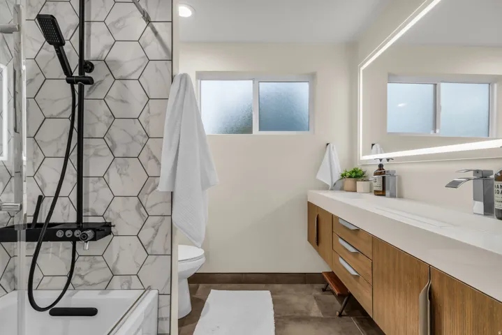 Full bath featuring vanity and  shower combination