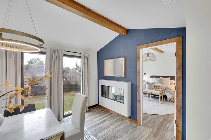 Home office with beamed ceiling, a multi sided fireplace, and light wood-style floors