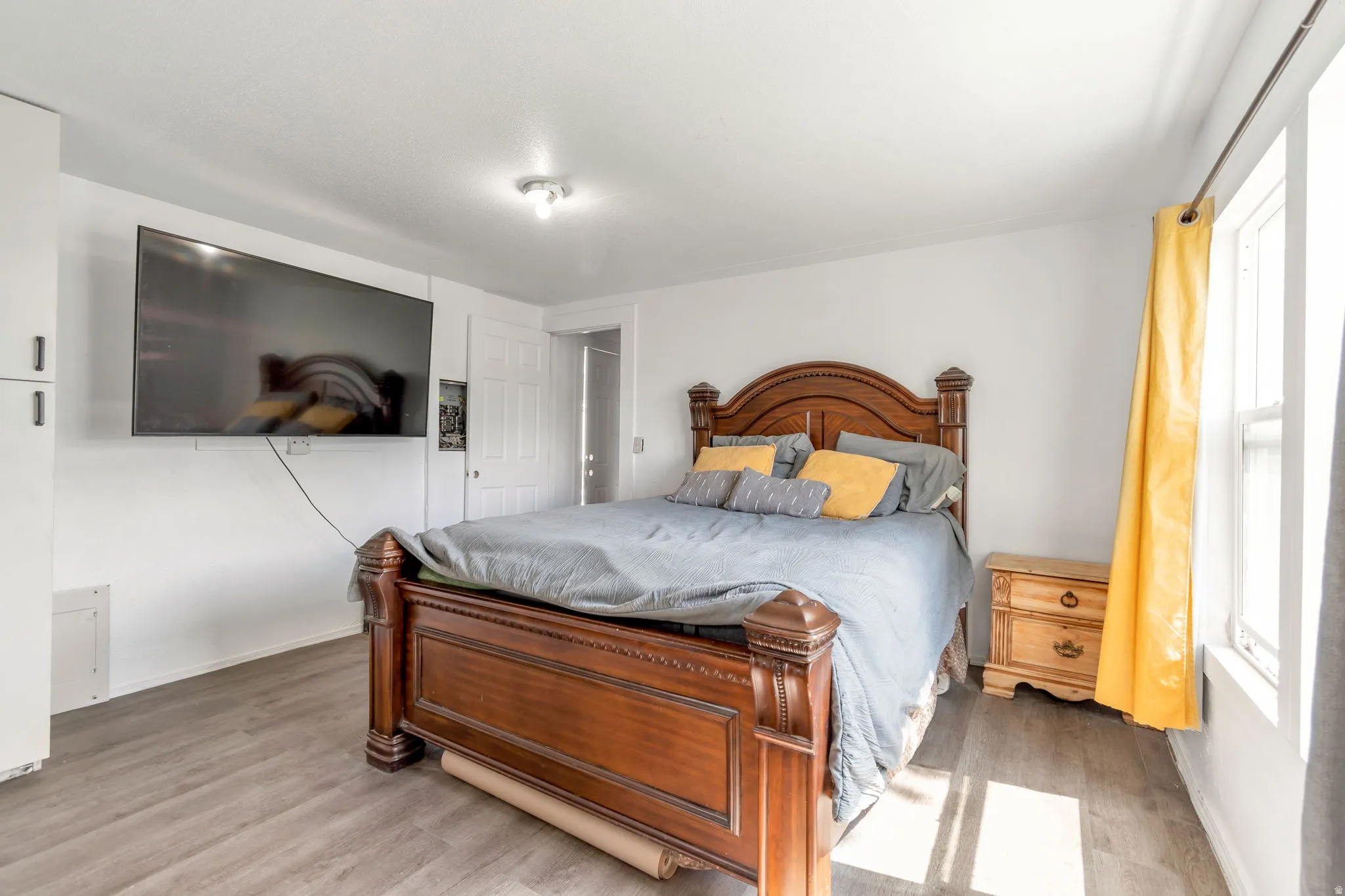 Bedroom featuring light wood-type flooring and baseboards