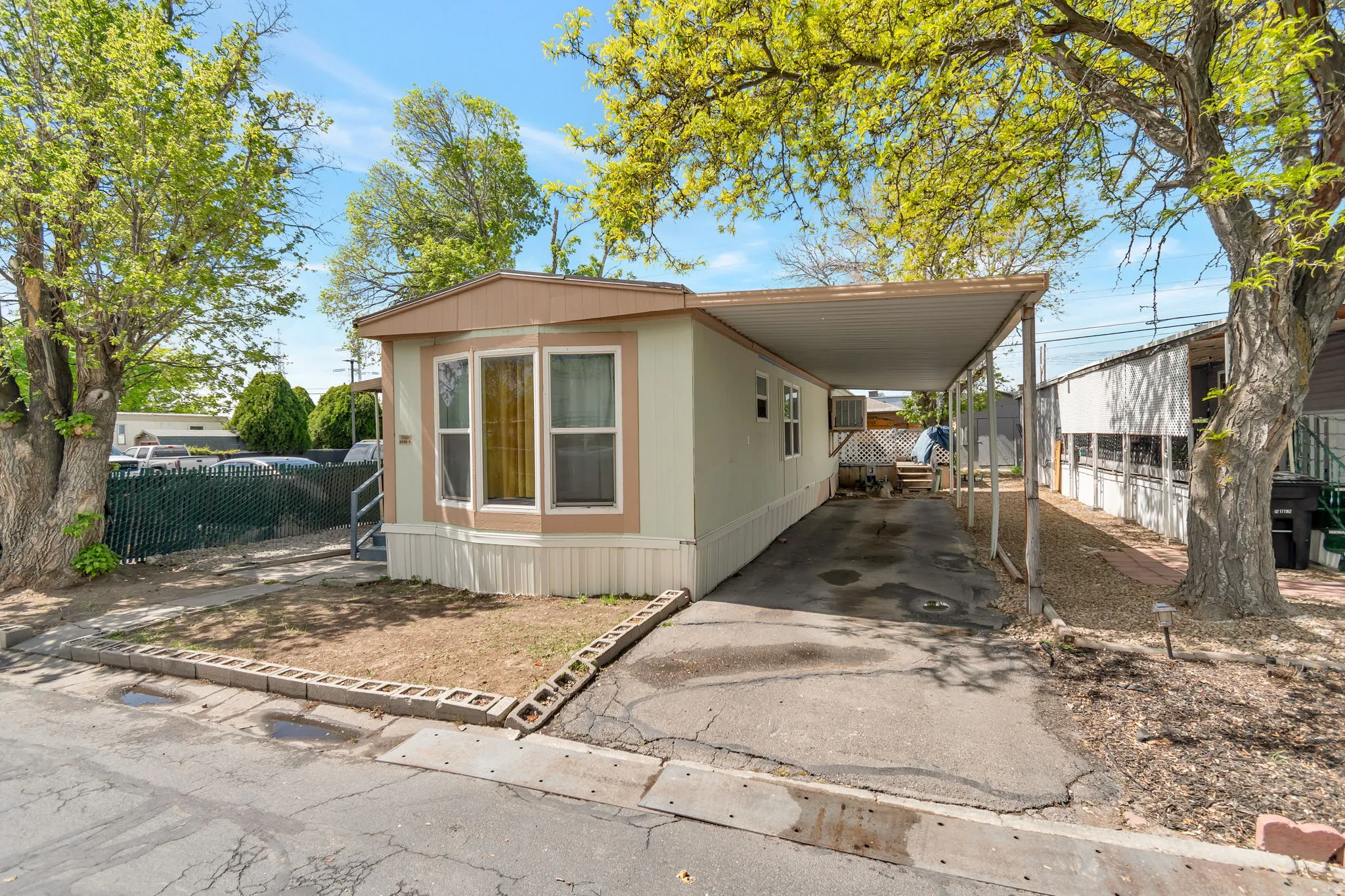 Manufactured / mobile home with a carport and driveway