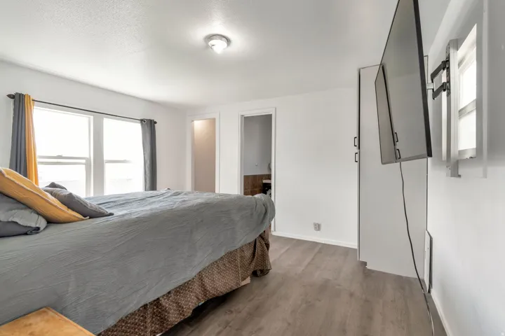 Bedroom with wood finished floors and a textured ceiling