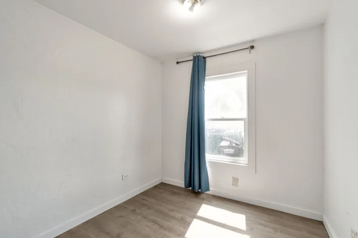 Spare room featuring light wood-type flooring and baseboards